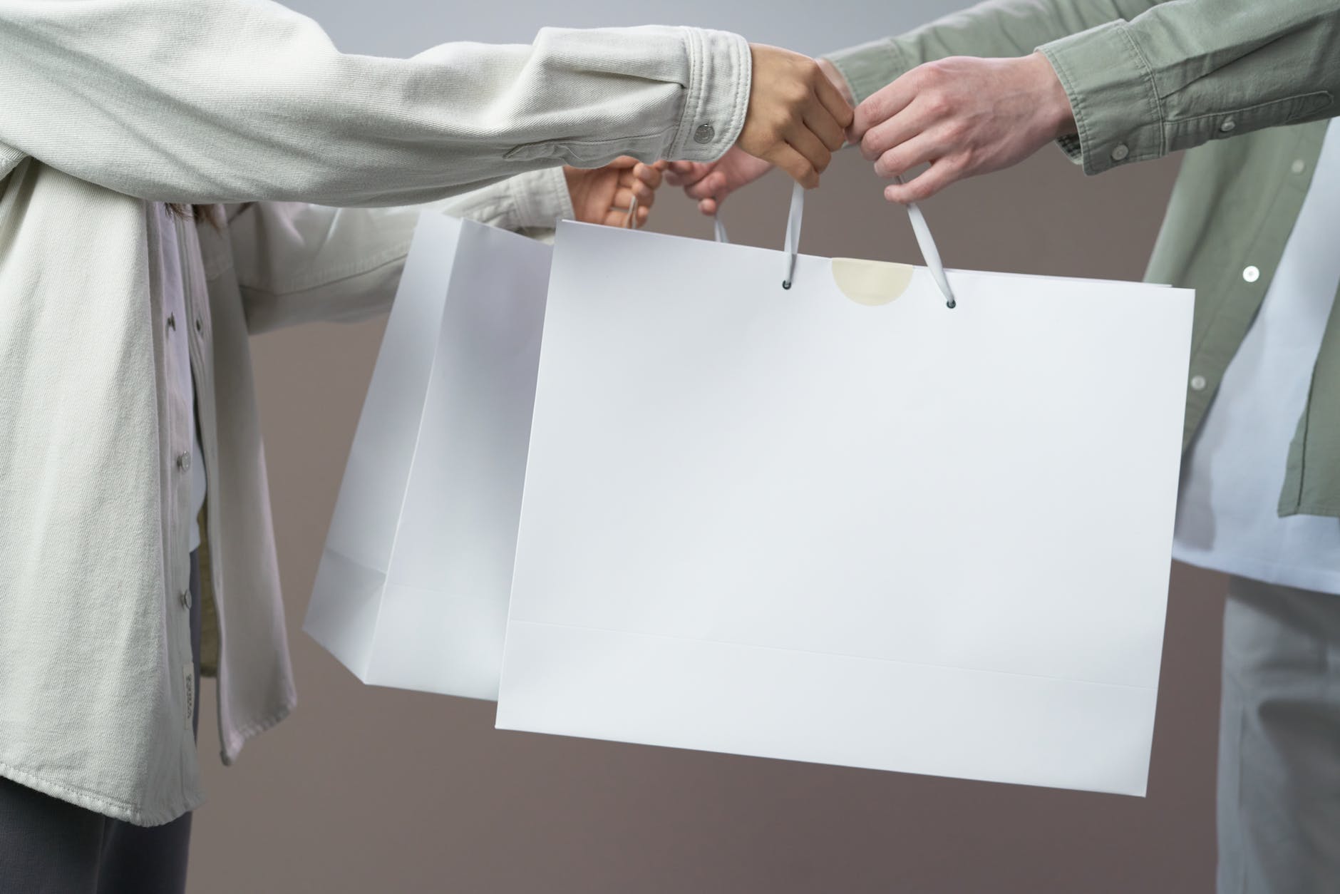 person in gray long sleeve shirt holding white paper